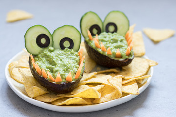 Funny alligator avocado guacamole dip and nachos
