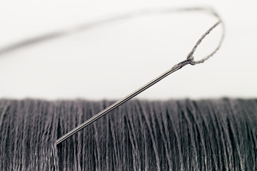 Needle and thread, on white background