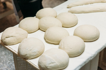 Fototapeta na wymiar Fresh dough on table. Raw Bakery Concept