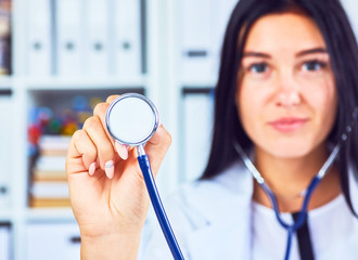 Medical doctor showing stethoscope close up in office background. Physician ready to examine patient.