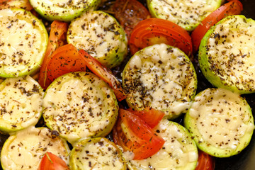 Homemade zucchini with tomato and cheese fried on iron pan. Close up Ideal breakfast.