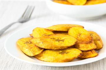 Fried slices of ripe plantains traditional snack and accompaniment in Latin America, photographed...