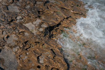 stone texture on the beach with water;