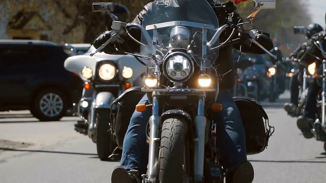 many subculture bikers group ride on the track on a Sunny summer day on custom motorcycles, a large-scale action of motorcyclists