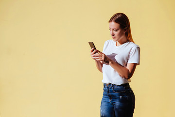 Portrait of smiling beautiful girl against of yellow background.