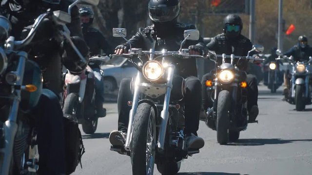 many subculture bikers group ride on the track on a Sunny summer day on custom motorcycles, a large-scale action of motorcyclists