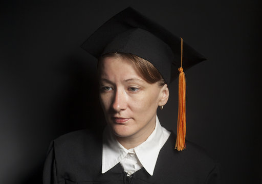 Portrait of Female bachelor in Black mantle and Graduation Cap
