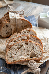A beautiful loaf of sourdough bread from white wheat on a plate on a linen edge. Homemade pastries