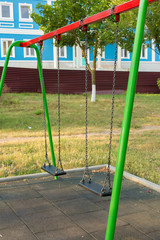 Fototapeta premium Children's entertainment complex, childhood, Child on a swing 