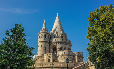 fairy tale white beautiful castle palace facade with towers on blue background in summer time...