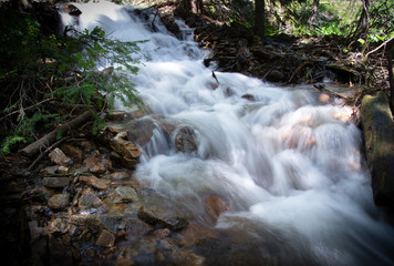 Time lapse waterfall rushing down the mountainside in the Rocky Mountains of Colorado