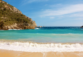 Fototapeta na wymiar Beautiful sandy beach in a bay at Paleokastritsa in Corfu, Greece