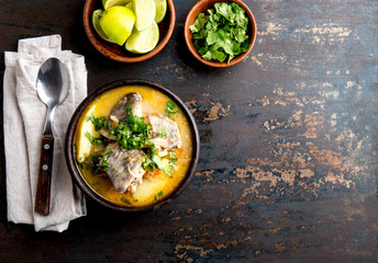 CHILEAN FOOD. Fish soup CALDILLO DE CONGRIO served in clay bowl, top view. copy space