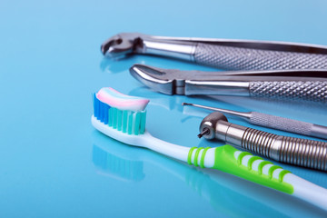 dental care toothbrush with dentist tools on mirror background