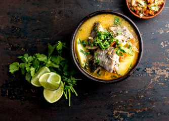 CHILEAN FOOD. Fish soup CALDILLO DE CONGRIO served in clay bowl, top view