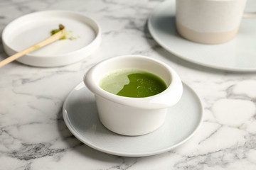 Chawan with fresh matcha tea on table