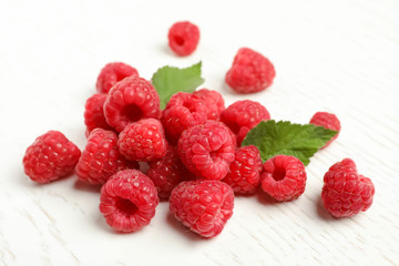 Ripe aromatic raspberries on table, closeup