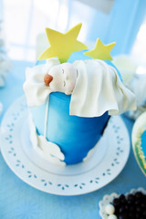 Delicious birthday, christening or baby shower cake decorated with sleeping newbotn.