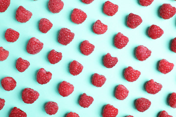 Flat lay composition with ripe aromatic raspberries on color background © New Africa