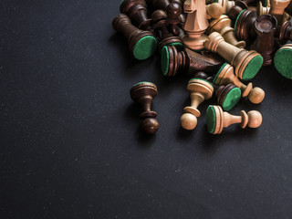 close up bunch of classic traditional chess figures on black surface © Mihail