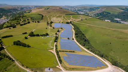 Aerial drone view of a large solar generation plant on a mountain top in the UK