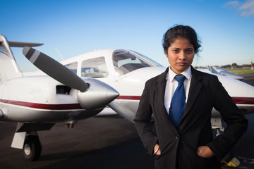 Female Pilot Standing in Front of Her Plane © Craig