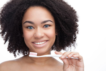 Beautiful young african teenage smile with brushing teeth . Dental health background.