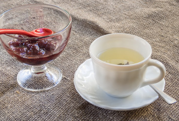 Cup of green tea and a jam with a jam