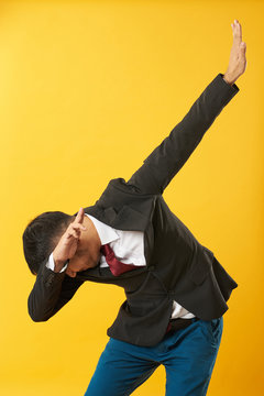 Young asian man showing dab