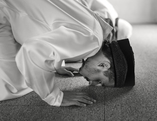 Muslim praying in Sujud posture - obrazy, fototapety, plakaty