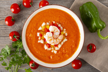 Soup gazpacho. Italian cuisine. Plate with soup in a white plate on a rustic background. Top View.