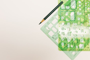 Green stencils with dark colored pencil on a white isolated background 