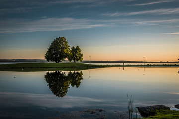 OTTAWA, ONTARIO / CANADA - JUNE 10 2018: TREES REFLECTION IN THE WATER IN THE MORNING.