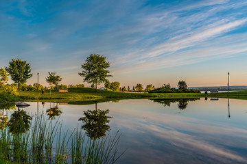 OTTAWA, ONTARIO / CANADA - JUNE 10 2018: TREES REFLECTION IN THE WATER IN THE MORNING.