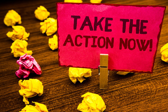 Conceptual hand writing showing Take The Action Now Motivational Call. Business photo showcasing Act Start Promptly Immediate Instantly Paperclip retrain pink card with letters wooden floor hunch.