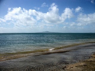 From Murrays Bay looking out to Mount Rangitoto in summer with a calm clear ocean tide. 