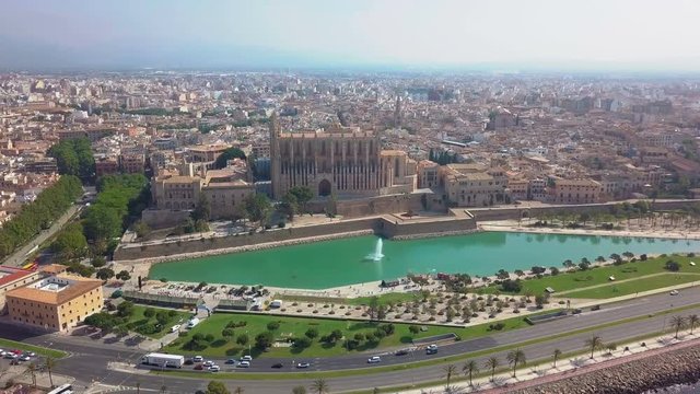 Aerial view Cathedral of Palma de Mallorca and Almudaina Castle. Beautiful gothic architecture overlooking the sea shore, Mallorca island, Spain.