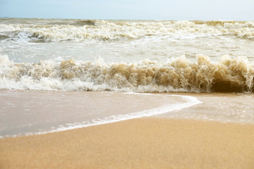 Soft ocean wave on sandy beach.