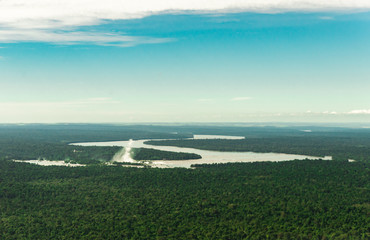 Fototapeta na wymiar Landscape aerial view of colorful Iguazu falls waterfall, rivers, rainforest with trees, jungle, and fields