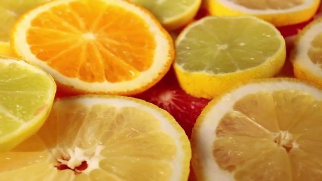 Lemon yellow lime slices rotating pattern macro texture background backdrop footage video.