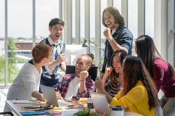 Group Of Asian and Multiethnic Business people with casual suit working with happy action and celebrate when project is completed in the modern workplace, people business group concept