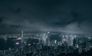 Hong Kong city with Victoria harbor and buildings at night, black and white