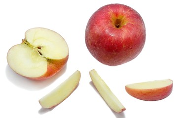 Top view red apples with slices isolated on white background.