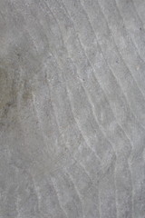 Background: sea sand at a shallow depth under a restless wave.