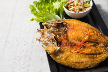 Deep fried seabass fish in black soy sauce, called Pla Krapong Tord Nam Plar Thai Food