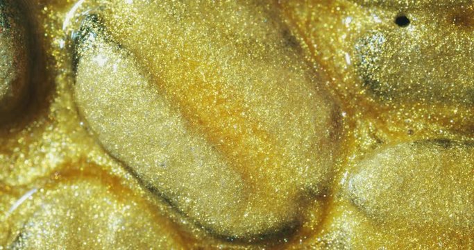 Coffee beans in gold oil.  gold oil paints. Macro. 4K.
