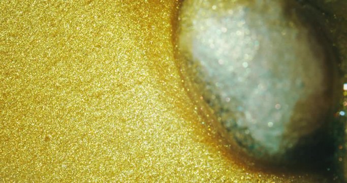 Coffee beans in gold oil.  gold oil paints. Macro. 4K.
