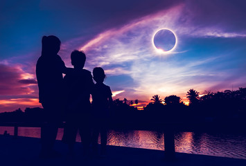 Natural phenomenon. Three person looking at total solar eclipse. - obrazy, fototapety, plakaty