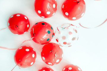Beautiful red dotted balloons floating at white ceiling. Wedding or children birthday party decoration interior