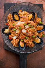 Above view of spanish paella with seafood, vertical shot, closeup